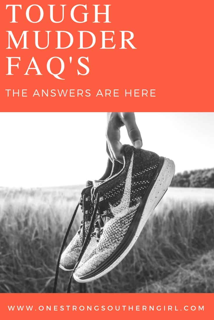 a hand holding a pair of tennis shoes in a field with text that says Tough Mudder FAQ's the answers are here