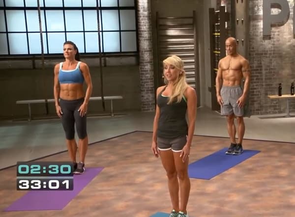 3 athletes standing at attention with arms at their sides in PiYo