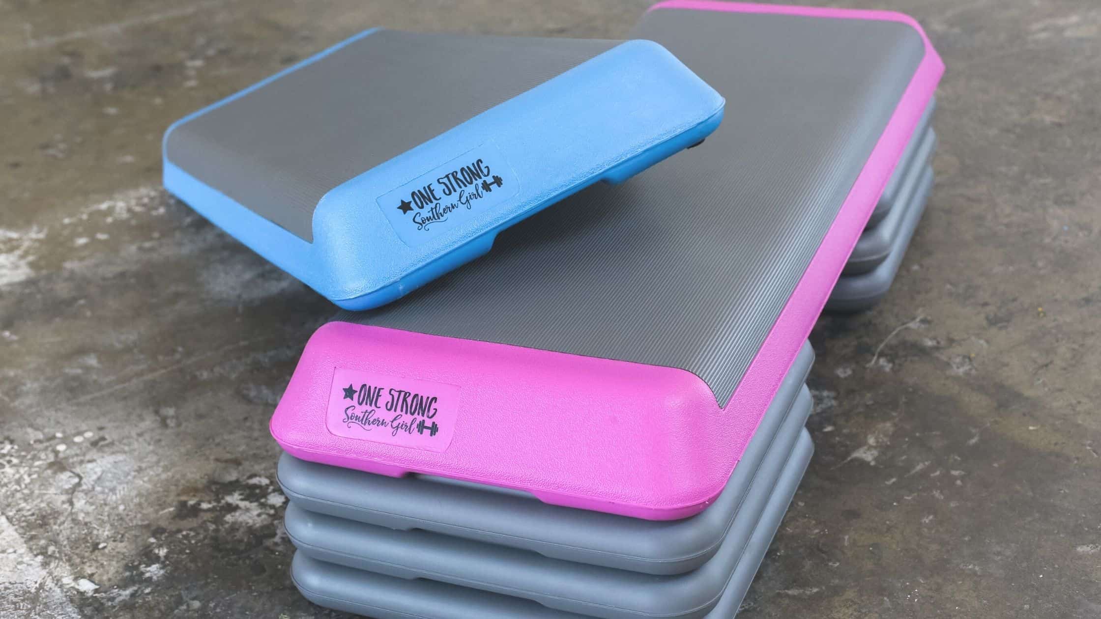 a pink and blue large aerobic step with 3 risers stacked together